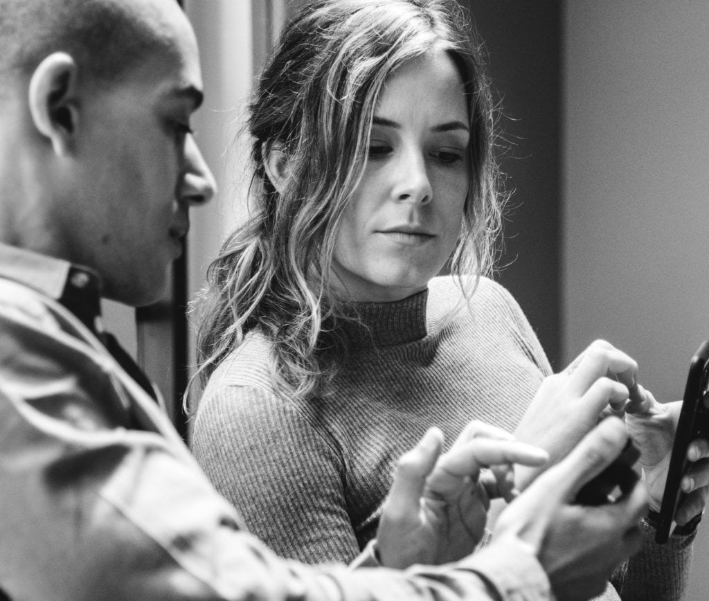grayscale photo of woman and man looking at a phone screen business thought leadership