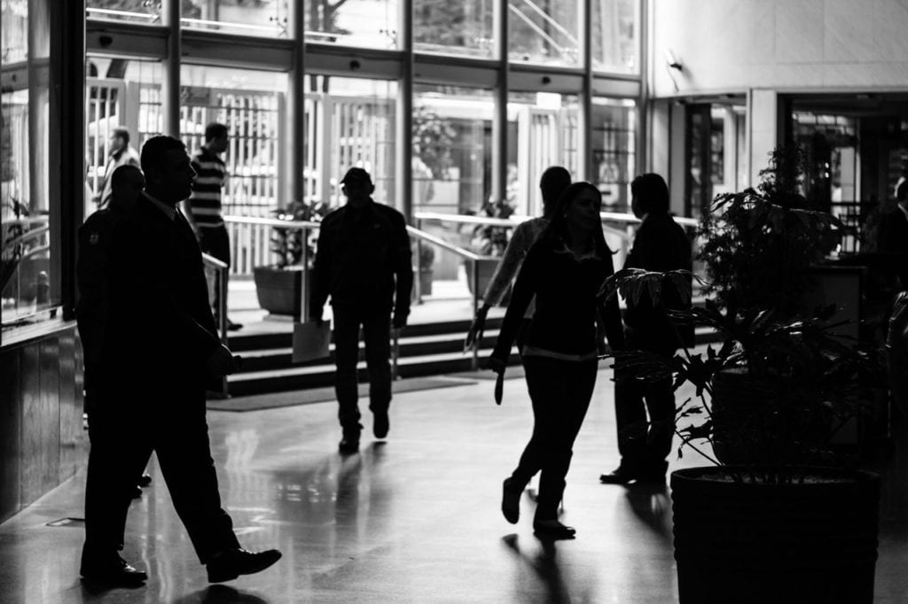 black and white photo of people walking in airport business thought leadership